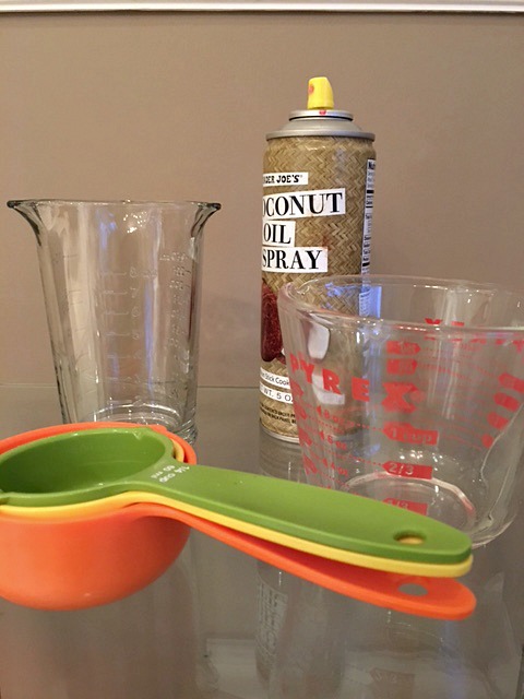 Spraying Measuring Cups with Cooking Spray