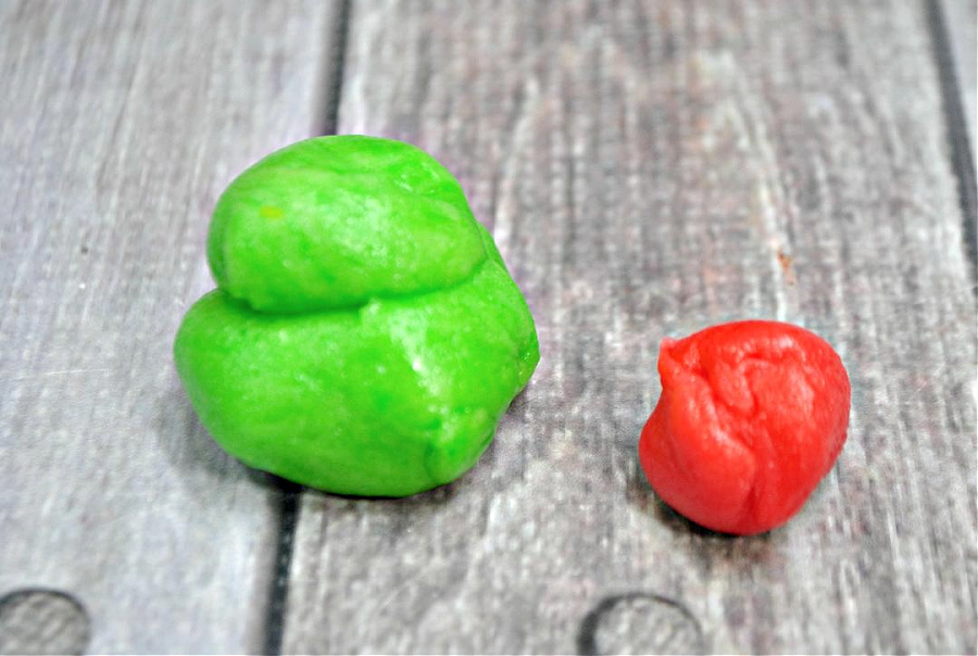 green dough and red dough on a wooden background