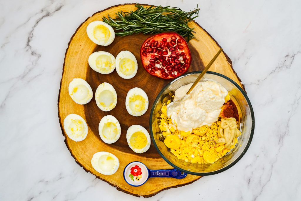 yolks, mayo, mustard and seasonings being mixed in a small bowl