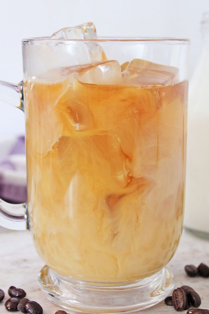ice and coffee in a clear glass mug 