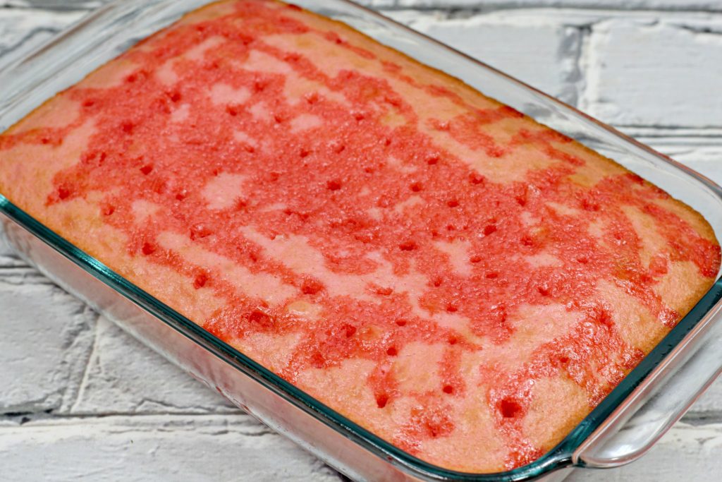 baked cake with holes and jello filling the holes 