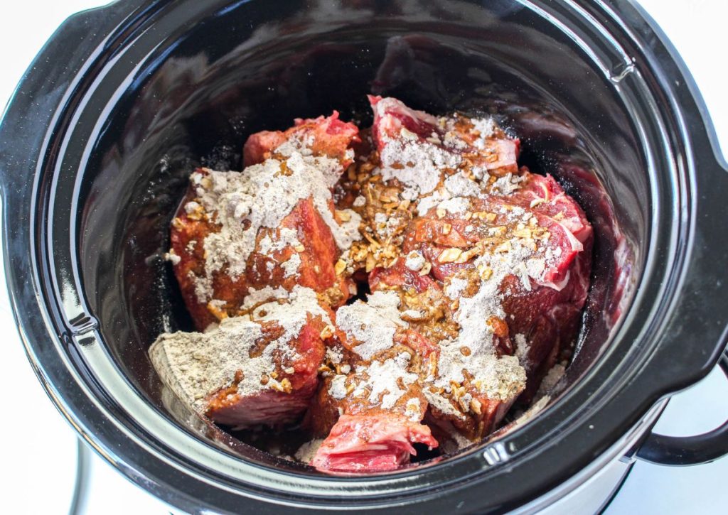 raw beef, gravy and onion soup mix in a slow cooker