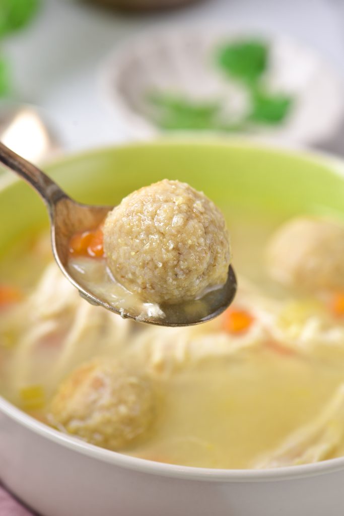 matzo ball held in the air on a spoon.