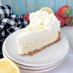 Slice of sour cream lemon cheesecake on a plate.