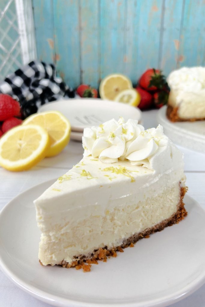 Slice of sour cream lemon cheesecake on a small plate.