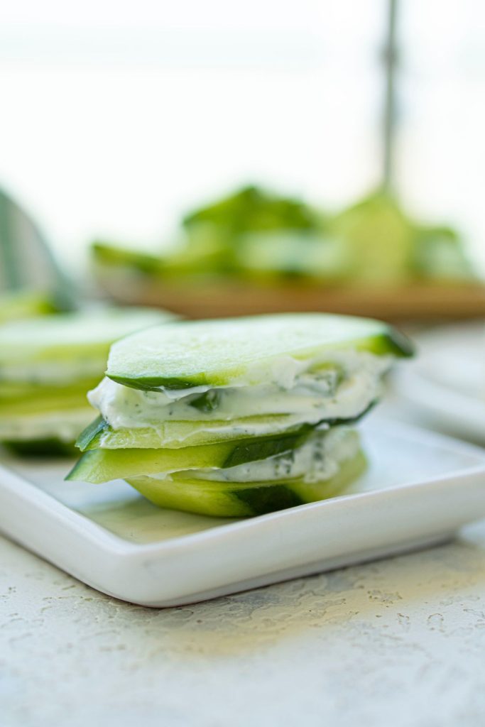 Cucumber slices with cream cheese spread on them.