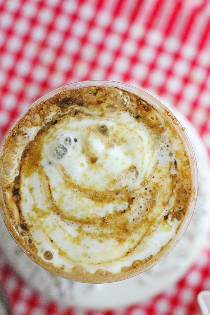 Cold foam on top of a cup of coffee.