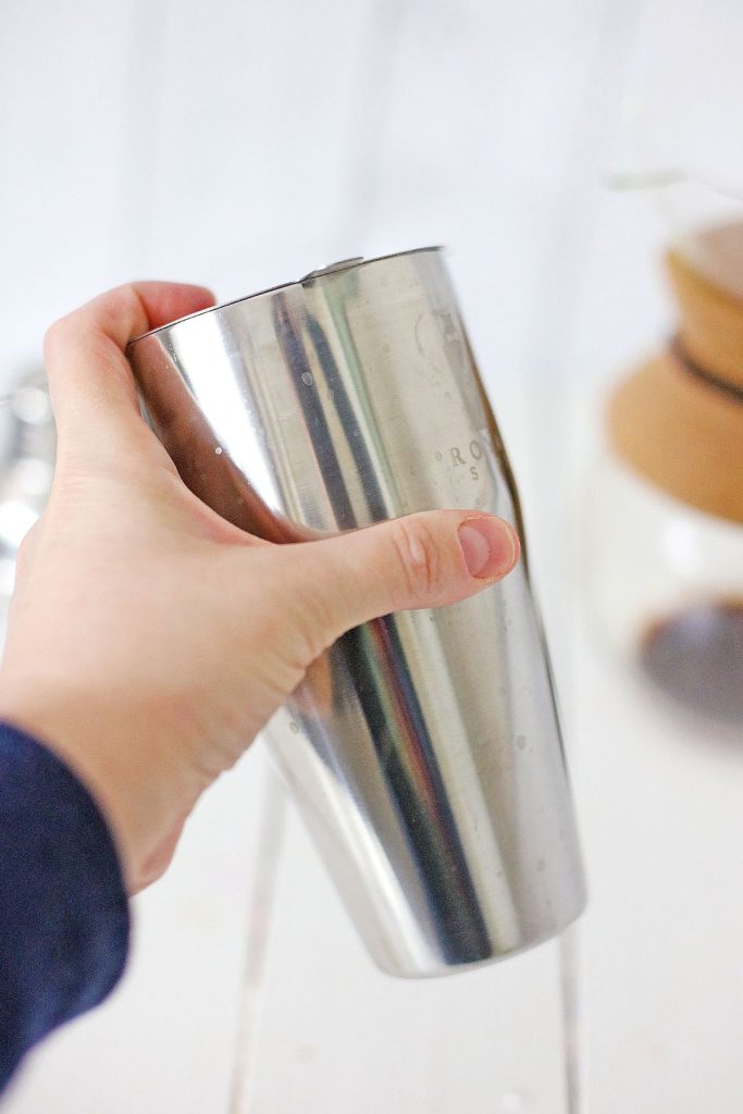 Drink being shaken in a cocktail shaker.