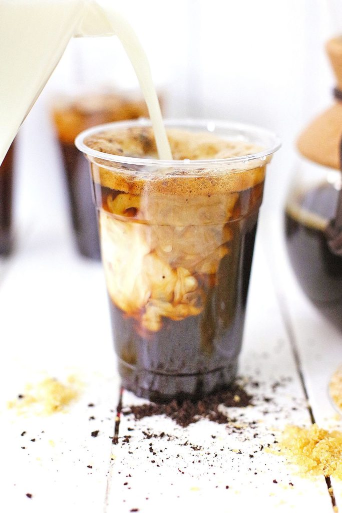Oat milk being poured into a cup.