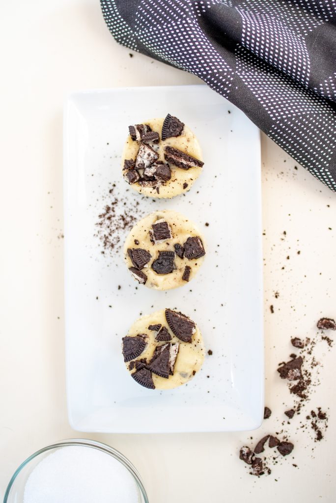 Overhead look at three Oreo cheesecakes on a white serving plate.