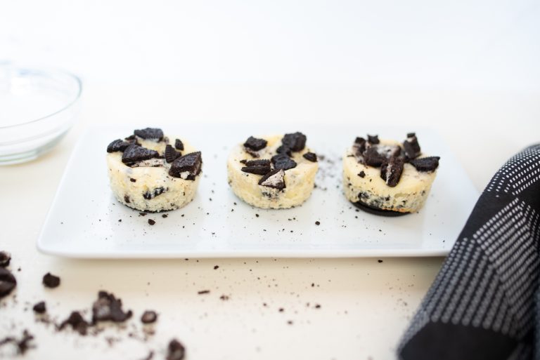 Three Oreo Cheesecake Bites on a white plate
