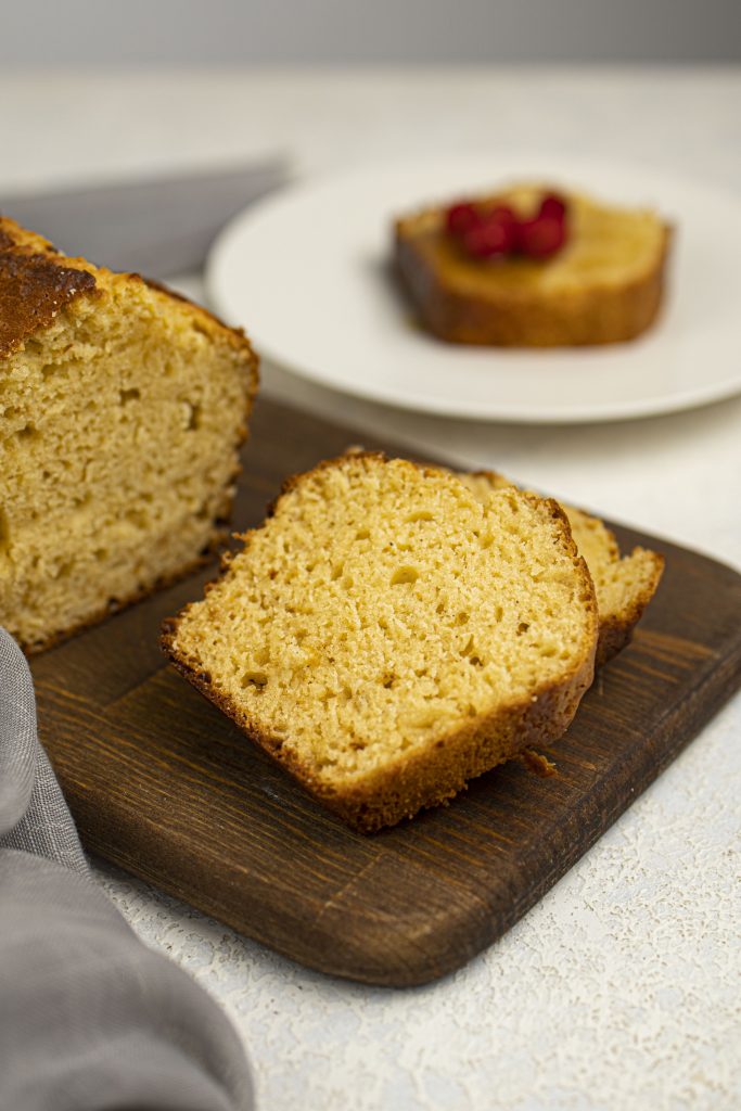 Slice of protein cake on a cutting board.