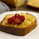 slice of protein cake with syrup being drizzled on top