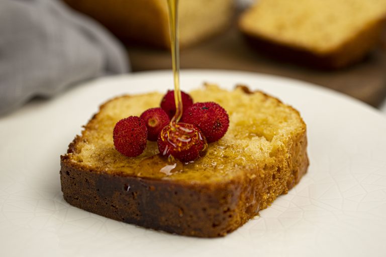 slice of protein cake with syrup being drizzled on top