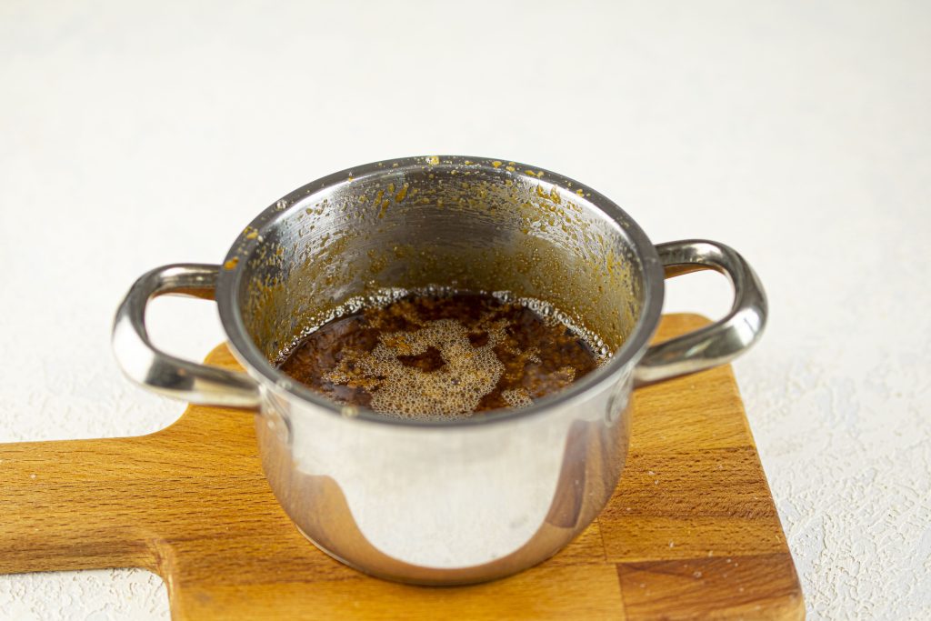 Melting the ingredients in a pot.