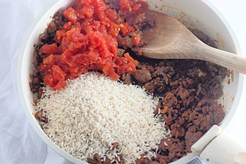 Adding in the tomato, and rice.